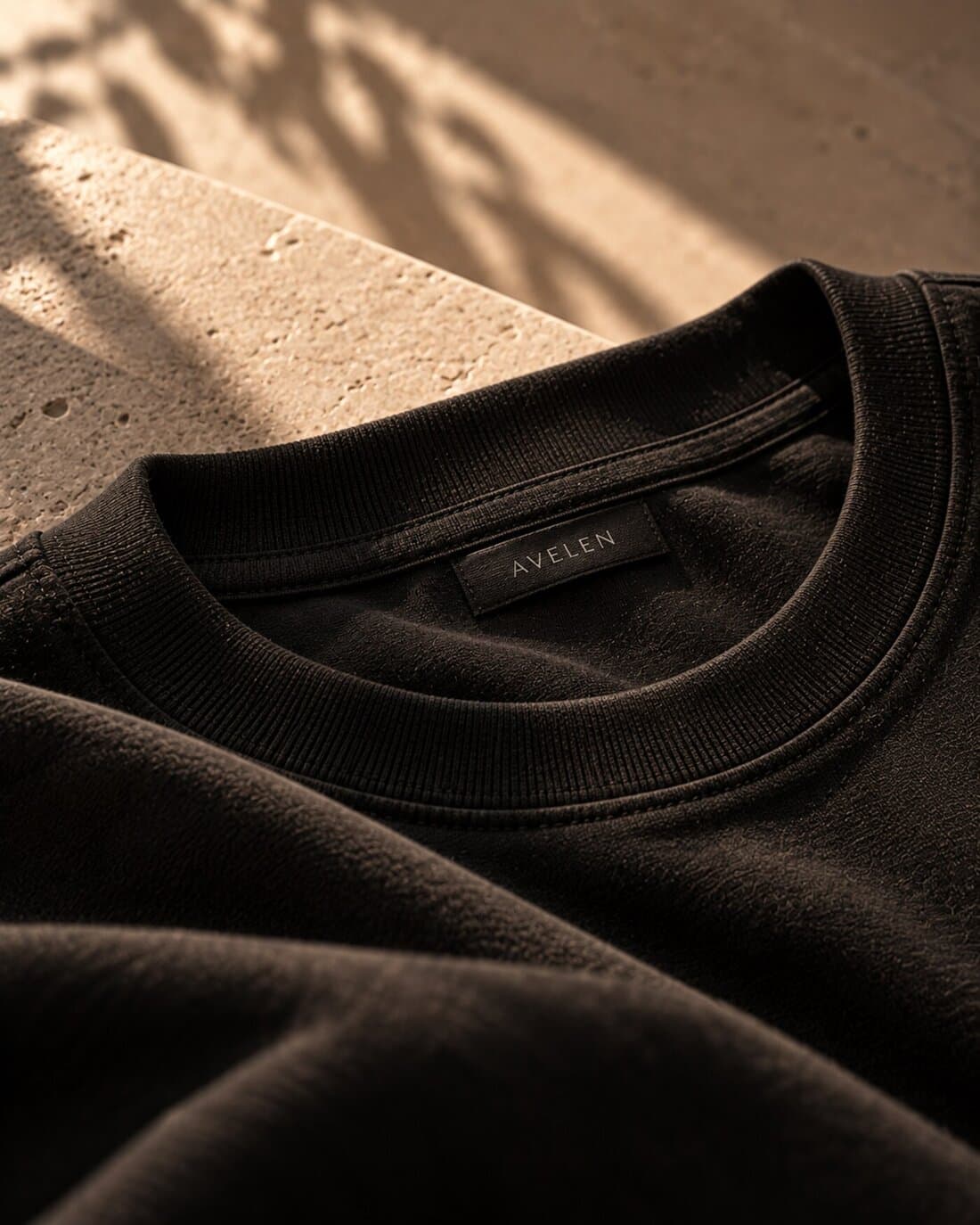 Detail of an AVELEN garment collar and woven label.